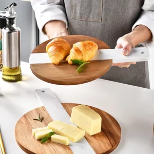 Elegant Nordic style marble and acacia wood cheese board for serving bread and steaks.