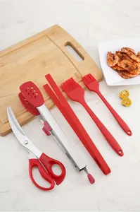 Detailed view of red silicone and stainless steel BBQ kitchen tool set with scissors and tongs.