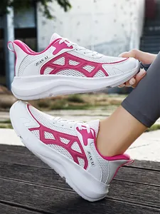 Macro view of white and pink breathable mesh athletic sneakers with thick cushioned soles