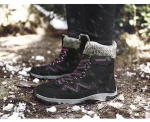 Detailed side view of durable black winter snow boots with pink accents and fur lining