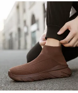 Detailed view of stylish brown high-top fly-knit sock sneakers with thick and durable soles