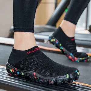 Professional black knit yoga fitness shoes with colorful splatter sole shown on treadmill