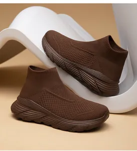 Macro view of brown high-top sock sneakers featuring breathable fly-knit mesh and ripple sole
