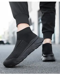 Detailed macro view of black high-top sock sneakers featuring breathable fly-knit mesh material