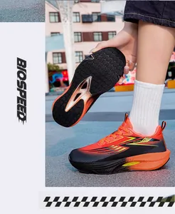 Detailed view of ultra-lightweight orange and black running shoes featuring the sole