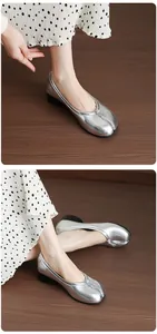 Close-up detail shot of silver split-toe Tabi ballet flats featuring chunky mid-heels and soft leather