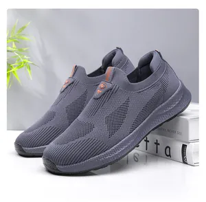 Dettaglio laterale di scarpe grigie in maglia su supporti bianchi in stile minimalista