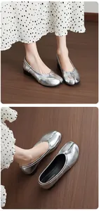 Detailed view of silver split-toe Tabi ballet flats with elegant block heels and soft leather finish.