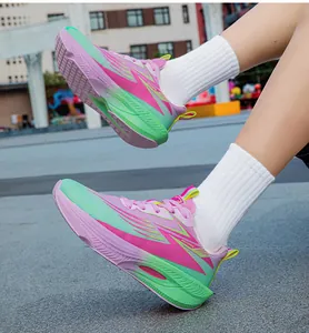 Detailed view of lightweight pink and green gradient running shoes worn with white socks