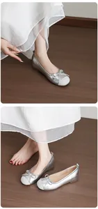 Detailed view of silver French style bow ballet flats with comfortable round toe design
