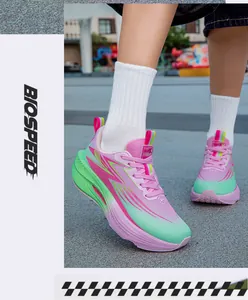 Close-up of lightweight pink and green gradient running shoes designed for active youth.