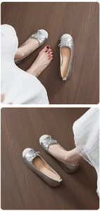 Detailed view of silver ballet flats with bow and sparkling round toe finish.
