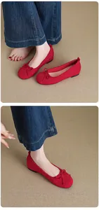 Close-up detail of red French-style ballet flats featuring a delicate bow design