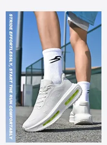 Detailed view of white mesh running shoes with green air cushion on outdoor paved ground.