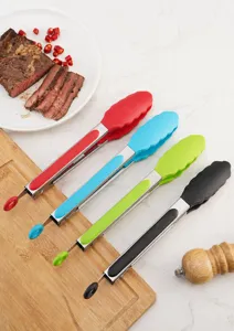 Close-up of four colorful silicone food tongs for BBQ and kitchen use on marble surface