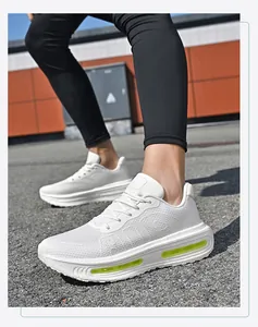Close-up of white breathable mesh running shoes with lime green air cushion sole