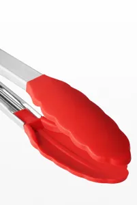 Macro view of the red heat-resistant silicone head of a kitchen tong with wavy edge