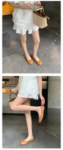 Elegante orangefarbene Leder-Ballerinas mit schickem Schleifen-Detail und runder Kappe
