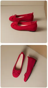 Close-up of red suede ballet flats featuring a delicate bow and round toe design