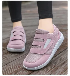 Detail of mauve mesh walking shoes with velcro straps for seniors