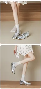 Elegant silver metallic Mary Jane ballet flat shoes with cross strap detail on model