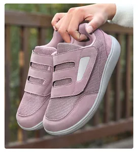 Close-up of mauve walking shoes with mesh upper and dual hook-and-loop straps
