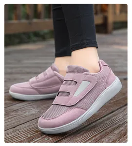 Close-up of breathable purple mesh walking shoes with velcro straps on wooden deck surface