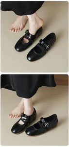 Close-up detail of black vintage Mary Jane ballet flats with buckle straps