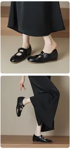 Detail view of vintage black Mary Jane flats with criss-cross straps and buckle
