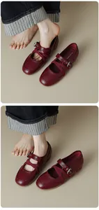 Detailed view of red retro Mary Jane ballet flats featuring cross straps and buckles