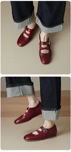 Detailed side and top view of red vintage Mary Jane flat shoes with cross straps