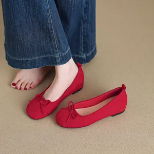 Elegant red ballet flats with delicate bow detail and hidden wedge height for women
