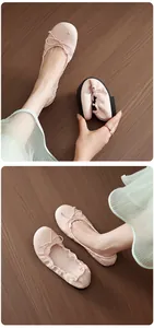 Light pink flexible soft sole ballet flats featuring a dainty bow detail for women