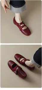 Detailed top view of retro burgundy Mary Jane flats with elegant criss-cross elastic straps