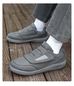 Comfortable grey velcro walking shoes with breathable mesh worn on a wooden surface