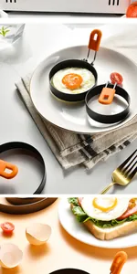 Close-up view of non-stick stainless steel egg frying ring with orange silicone handle