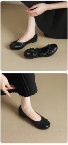 Detail of black French ballet flats with soft leather and delicate bow ornament.