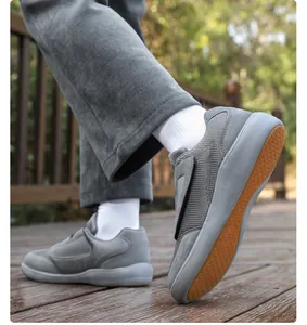 Side view of gray mesh Velcro walking shoes for elderly on wooden deck outdoors