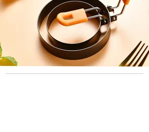 Detail of non-stick stainless steel egg rings with heat-resistant orange handles