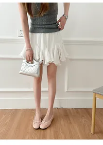 Close-up detail view of a model wearing pink French style ballet flats with bow detail