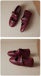 Close-up detail of the cross straps and metallic buckle on red vintage Mary Jane flats