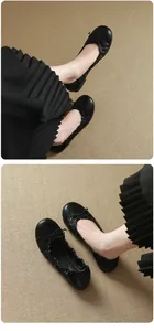 Elegant French style black ballet flats featuring delicate bow detail and soft leather sole