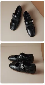Close-up view of black retro Mary Jane ballet flats with cross straps and buckles.
