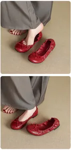 Detailed close-up showing red ballet flats featuring a delicate bow and premium soft leather texture
