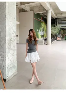 Elegant model wearing French style ballet flats with bow detail in a modern outdoor setting