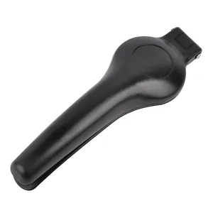 Black manual chestnut opener and nutcracker tool for kitchen use on white background