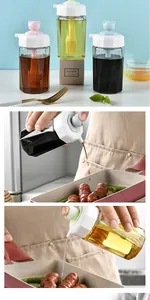 Detailed view of silicone oil dispenser brush being used for cooking sausages in a pan