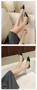 Elegant black patent leather pointed-toe flats with hollow-out design shown on feet.