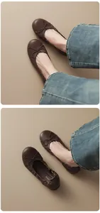 Close-up detail of dark brown French style ballet flats with elegant bow decoration