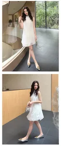 Model wearing elegant silver pointed toe flat shoes with a decorative gold buckle detail